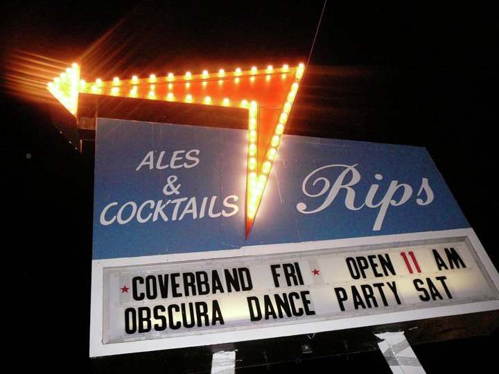 The vintage Rips Ales & Cocktails neon sign at night