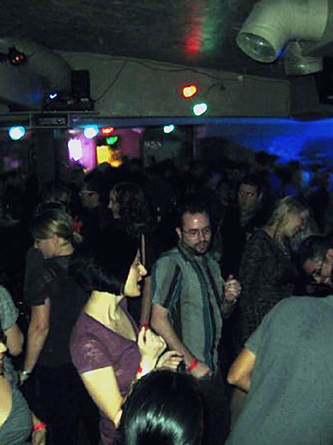 Crowd under blue stage lights at Rips